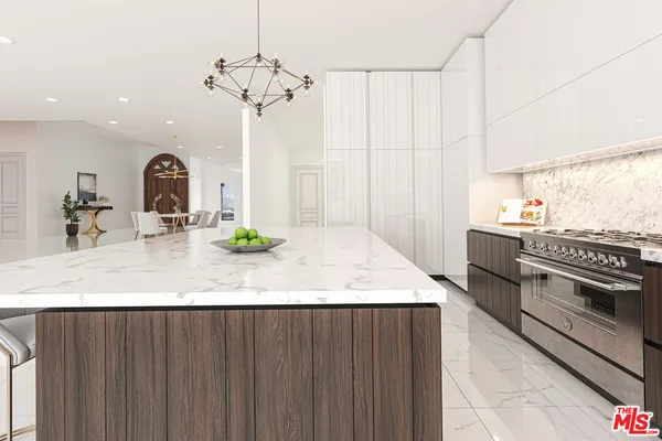 a kitchen with kitchen island granite countertop a sink stainless steel appliances and cabinets