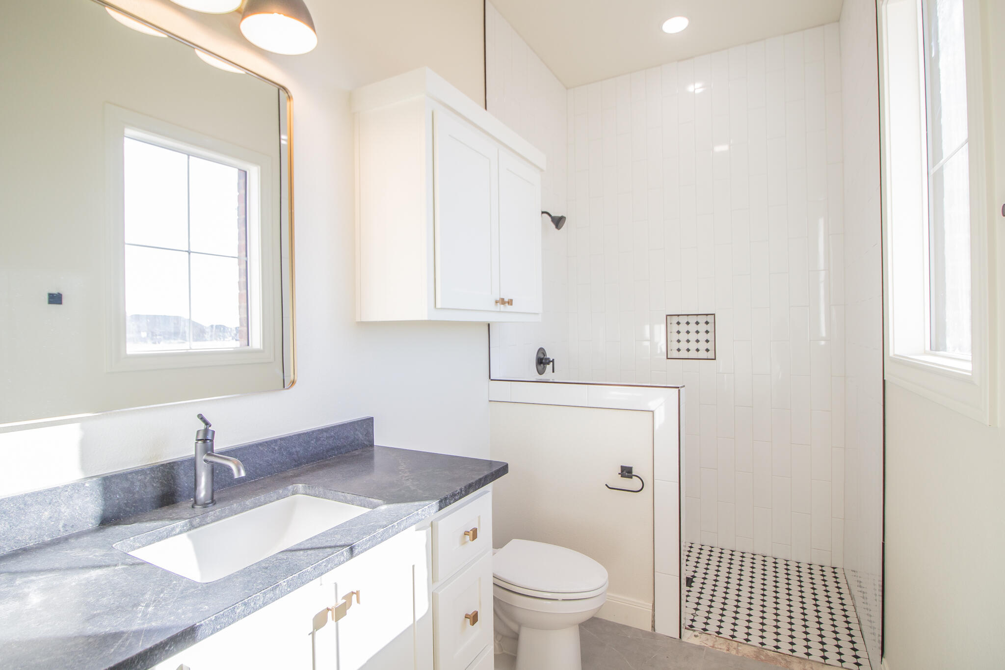 303 Juniper New Home, TX 79381 - Photo 19 of 31 a bathroom with a granite countertop sink mirror vanity and toilet