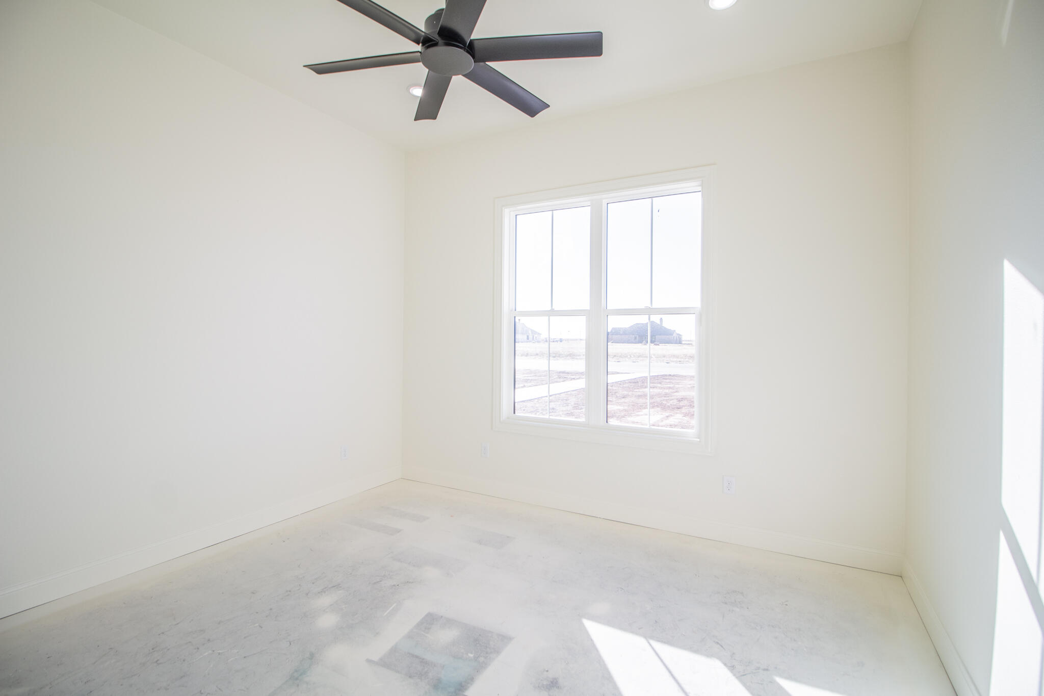 303 Juniper New Home, TX 79381 - Photo 21 of 31 an empty room with a window and a fan