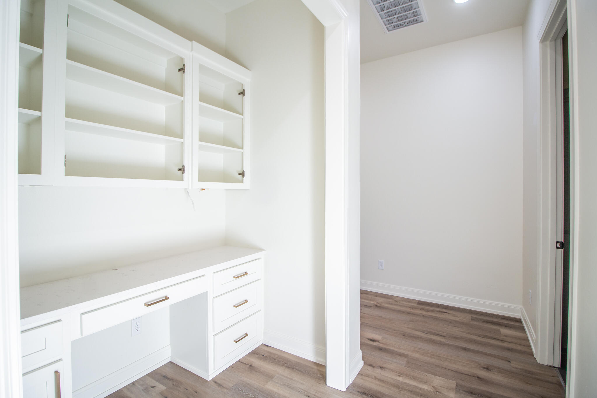 303 Juniper New Home, TX 79381 - Photo 22 of 31 a view of white cabinets and wooden floor