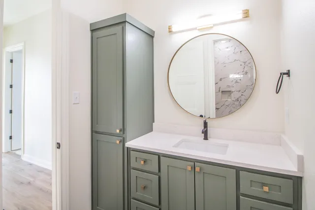 a bathroom with a sink and a mirror