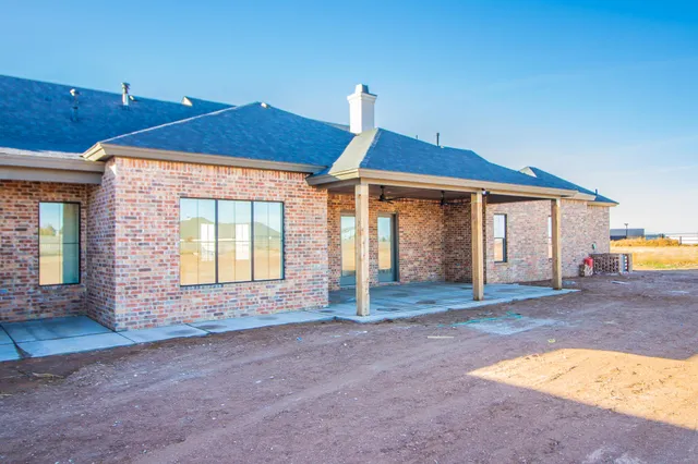 a view of an house with backyard space and balcony