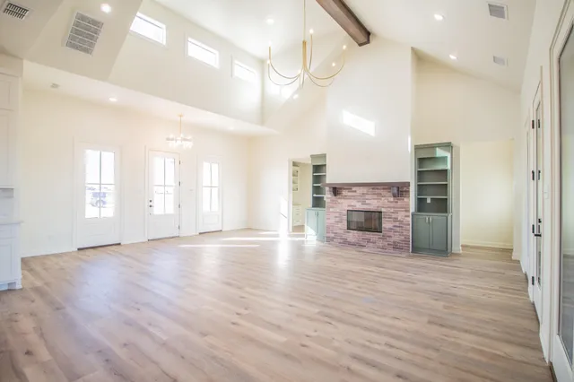 a view of a kitchen with a sink and a large window