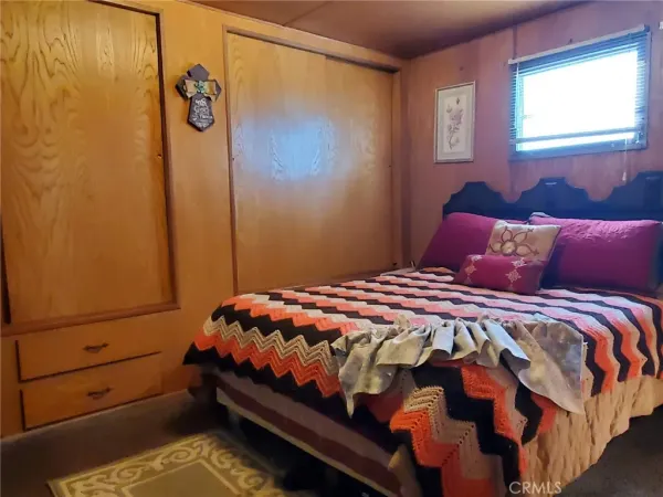 a bedroom with a bed and a dresser