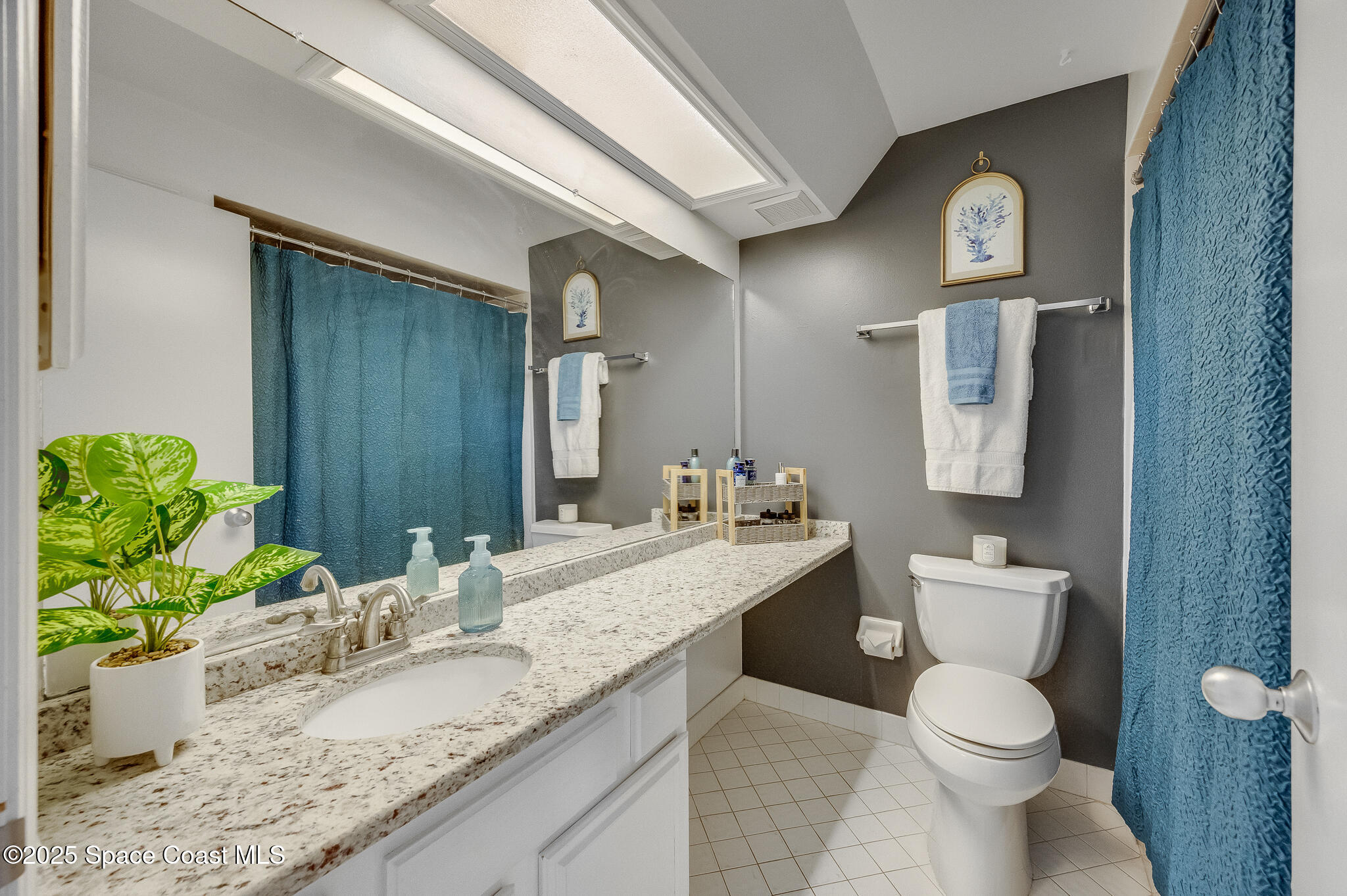 3319 Kirkland Road Northeast Palm Bay, FL 32905 - Photo 13 of 50 a bathroom with a granite countertop toilet sink and mirror