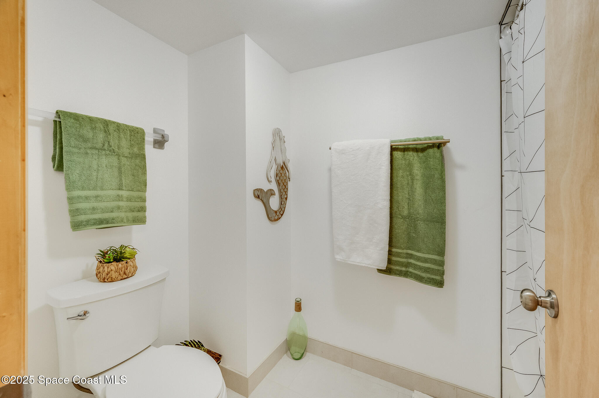 3319 Kirkland Road Northeast Palm Bay, FL 32905 - Photo 17 of 50 a bathroom with a toilet and a sink