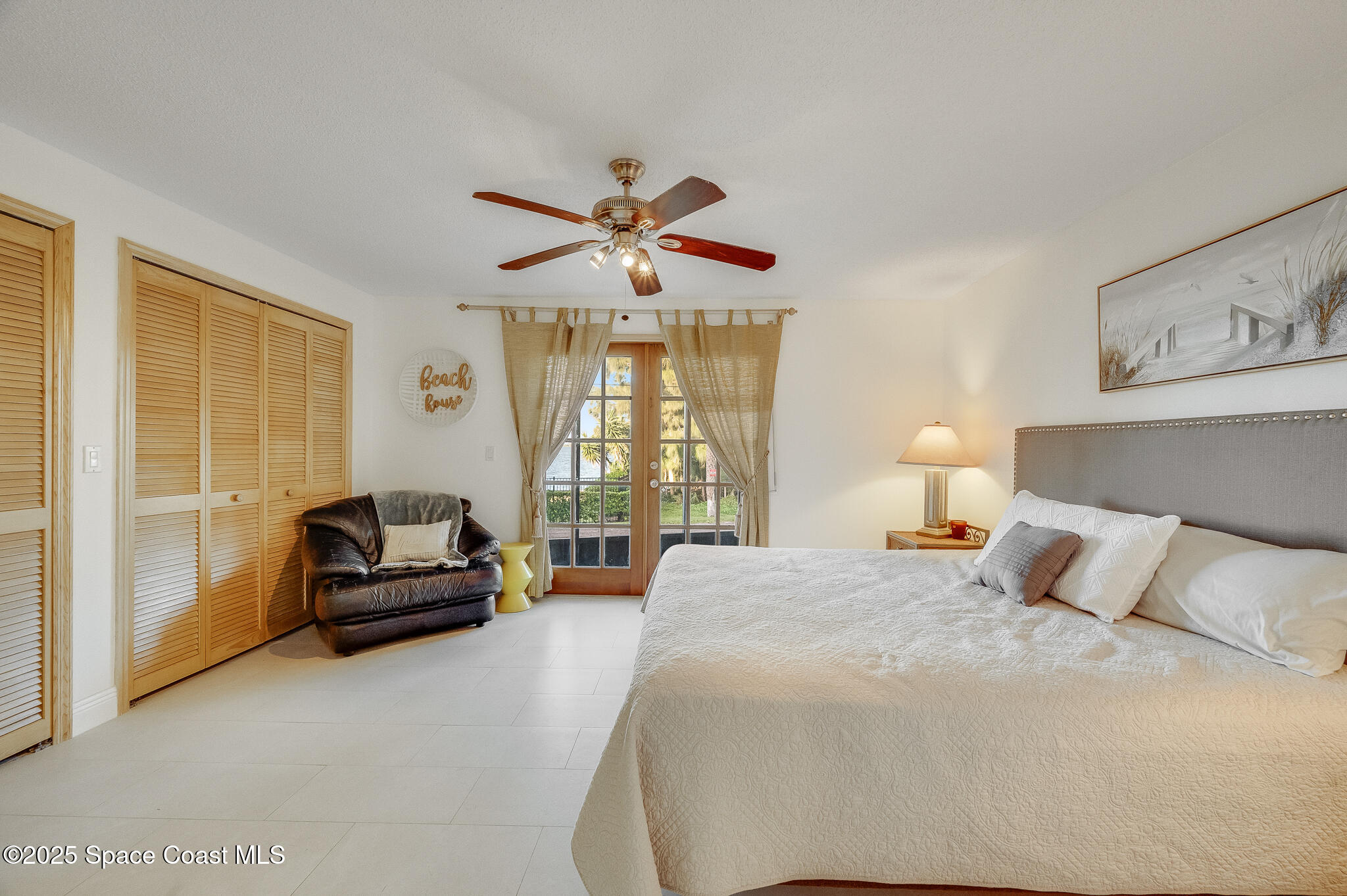 3319 Kirkland Road Northeast Palm Bay, FL 32905 - Photo 20 of 50 a bedroom with a bed a couch and a chandelier