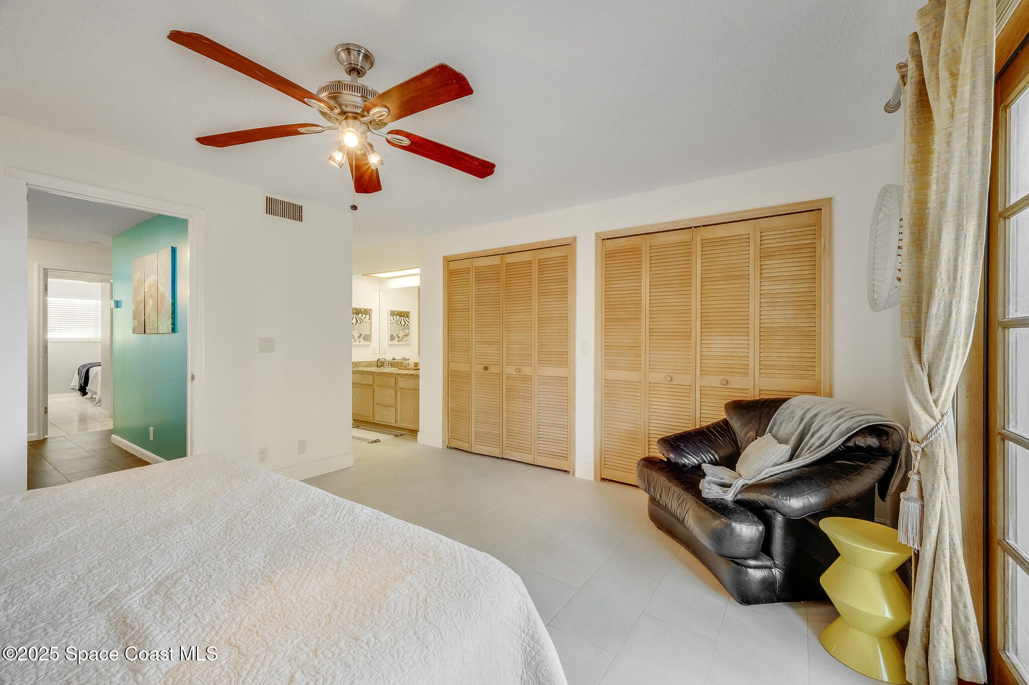 3319 Kirkland Road Northeast Palm Bay, FL 32905 - Photo 21 of 50 a bedroom with a bed and a chandelier