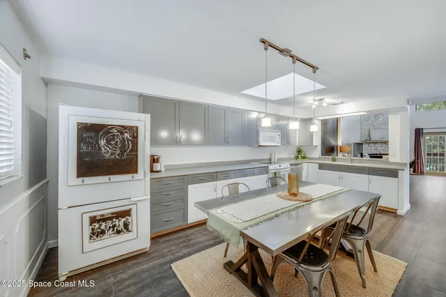 a spacious bathroom with a granite countertop sink and a mirror