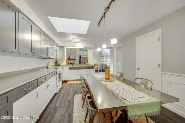 a kitchen with a table chairs stove and cabinets
