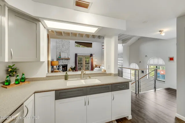 a kitchen with a sink cabinets and wooden floor