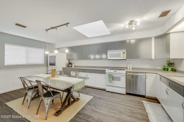 a bathroom with a granite countertop sink toilet and a mirror