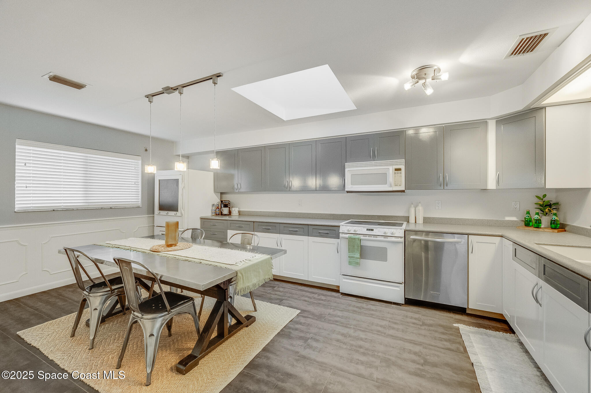 3319 Kirkland Road Northeast Palm Bay, FL 32905 - Photo 28 of 50 a kitchen with a table chairs stove and cabinets