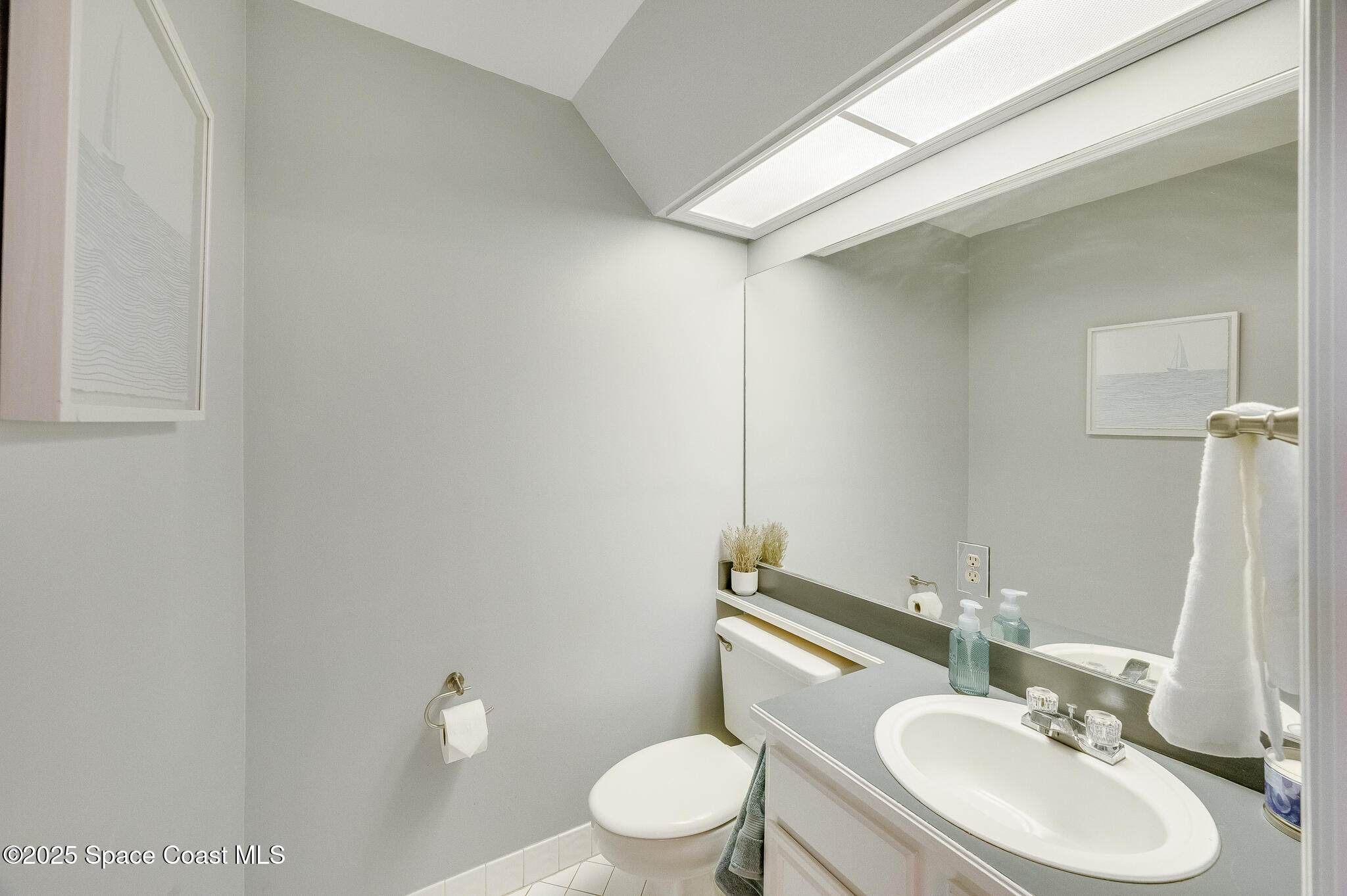 3319 Kirkland Road Northeast Palm Bay, FL 32905 - Photo 30 of 50 a bathroom with a granite countertop sink toilet and a mirror