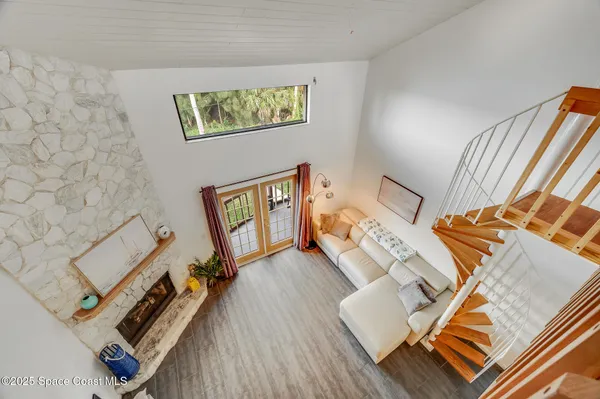 a view of staircase with furniture and a window