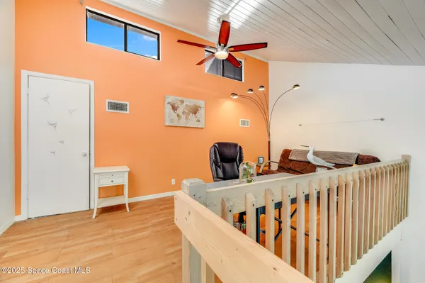 a view of a room with wooden floor and chair