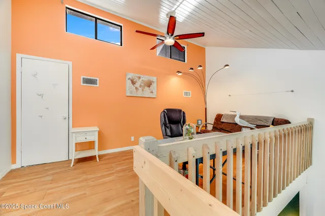 a view of a room with wooden floor and chair