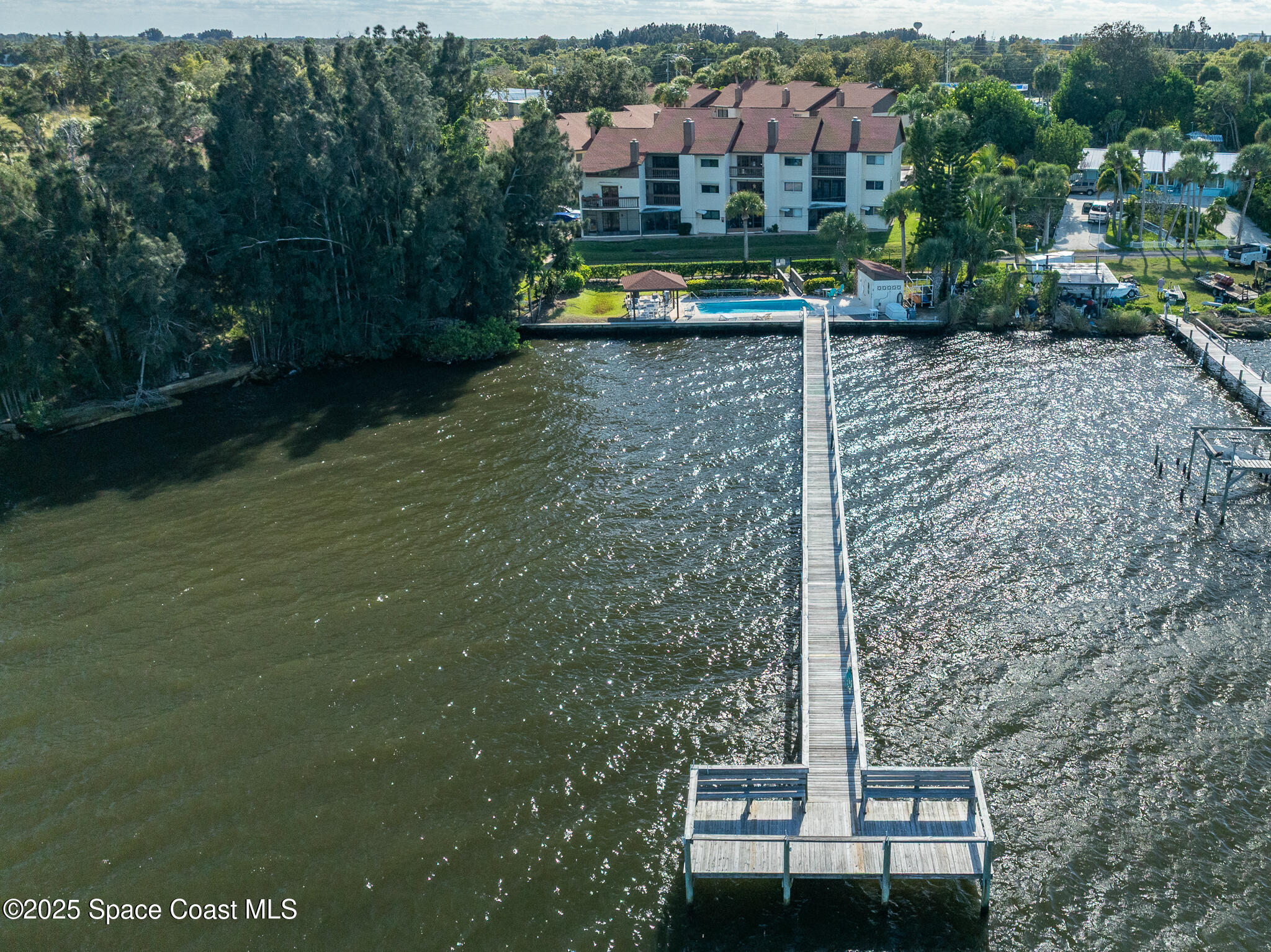 3319 Kirkland Road Northeast Palm Bay, FL 32905 - Photo 44 of 50 a view of a wooden house with a yard and large trees