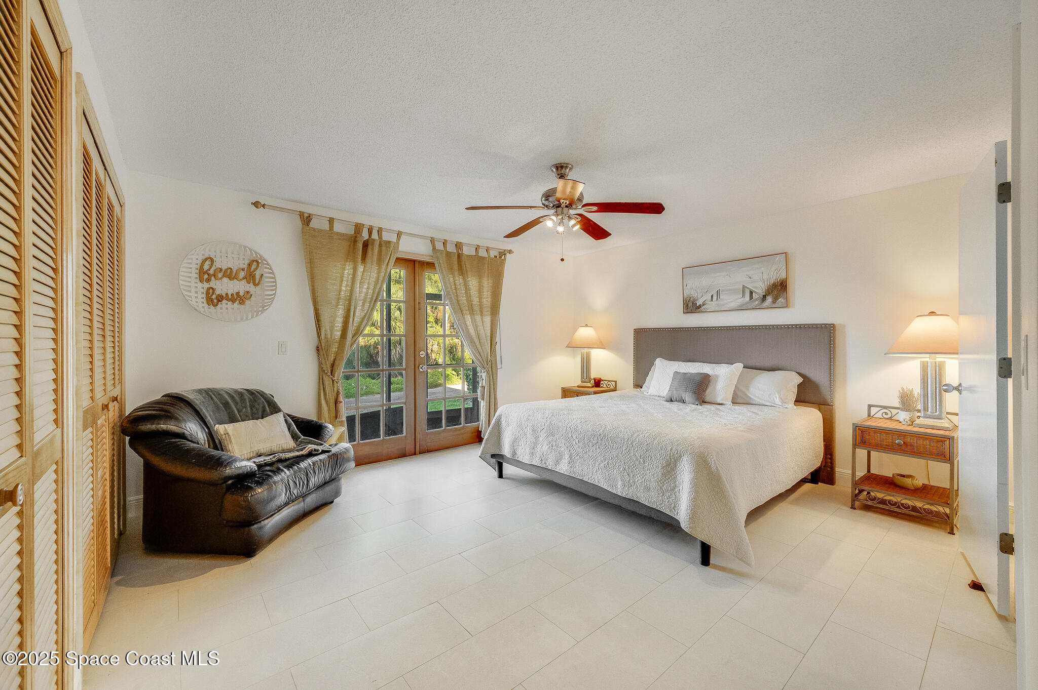 3319 Kirkland Road Northeast Palm Bay, FL 32905 - Photo 5 of 50 a spacious bedroom with a bed a couch and a window