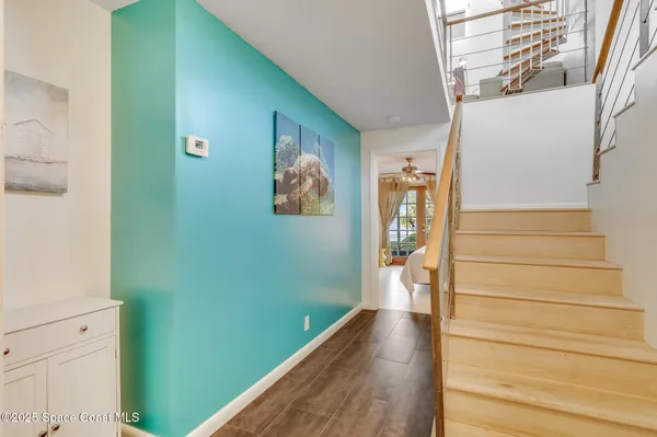 a view of entryway with wooden floor and stairs