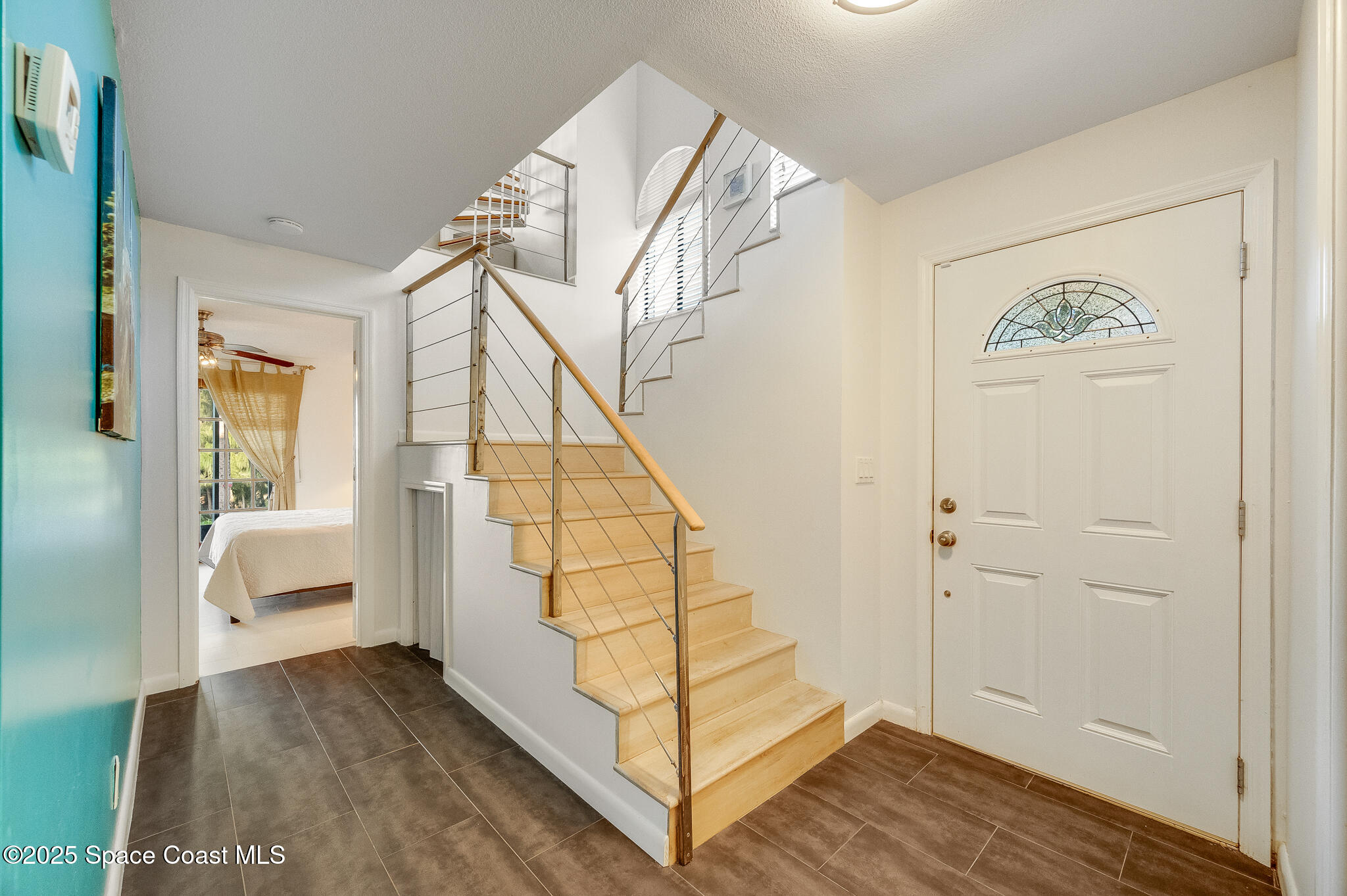 3319 Kirkland Road Northeast Palm Bay, FL 32905 - Photo 8 of 50 a view of entryway with wooden floor and stairs