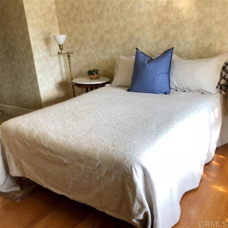 459 Lexington Circle Oceanside, CA 92057 - Photo 11 of 25 a large bed sitting in a bedroom next to a window