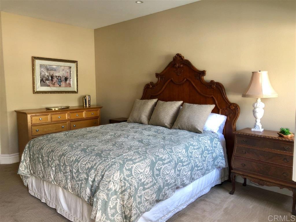 459 Lexington Circle Oceanside, CA 92057 - Photo 15 of 25 a bedroom with a bed and a lamp on dresser