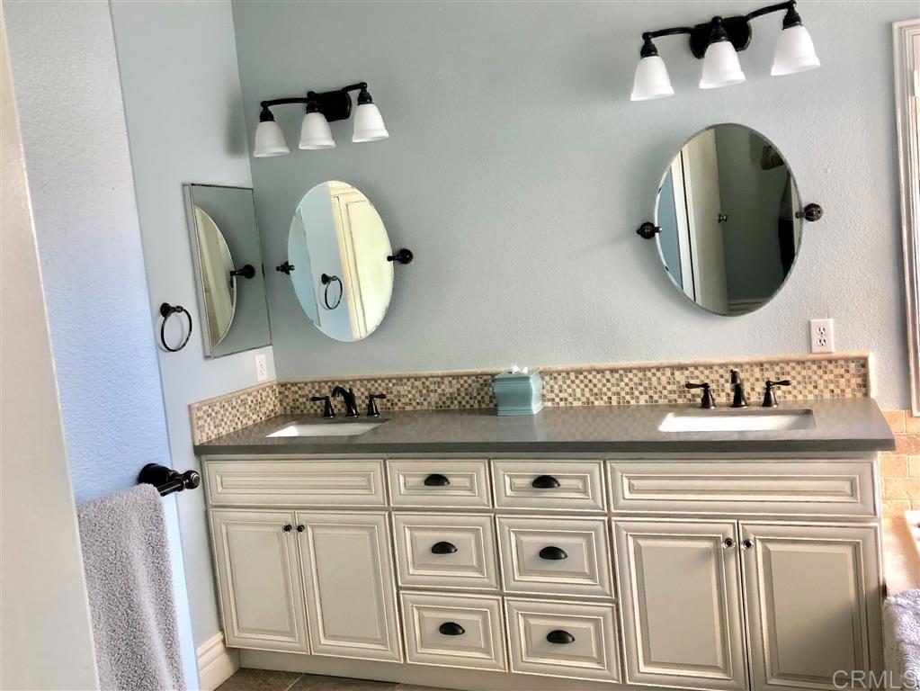 459 Lexington Circle Oceanside, CA 92057 - Photo 18 of 25 a bathroom with a sink and a mirror