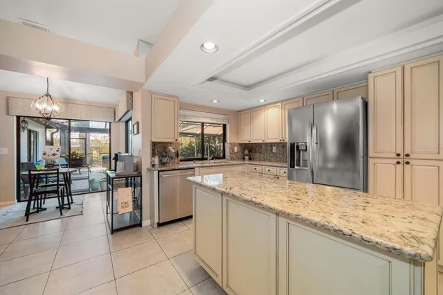 a kitchen with stainless steel appliances granite countertop a refrigerator and a stove top oven