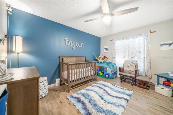 a bedroom with furniture and a wooden floor