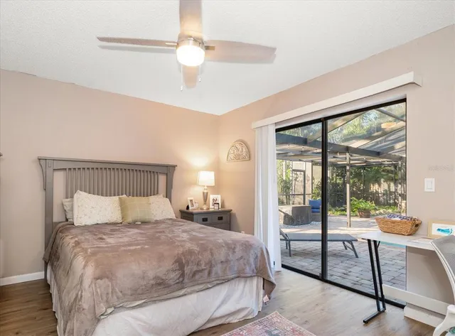 a bedroom with a bed a large window with table and chairs