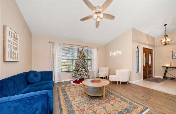 a living room with furniture potted plant and a window