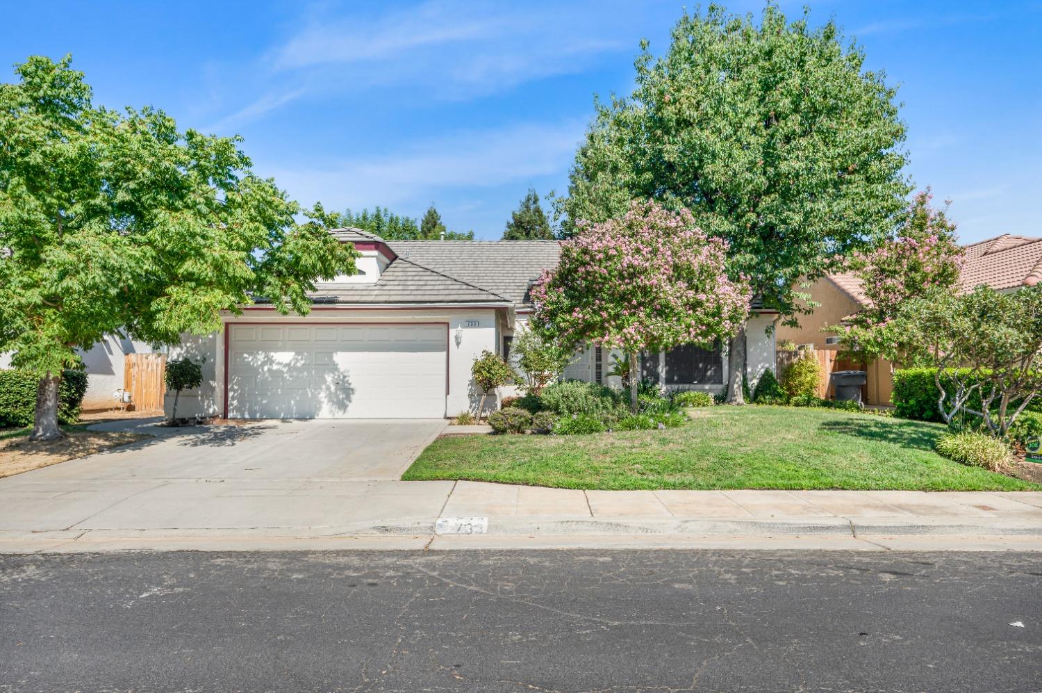 733 Applegate Avenue Clovis, CA 93611 - Photo 1 of 25 front view of a house with a yard and an trees
