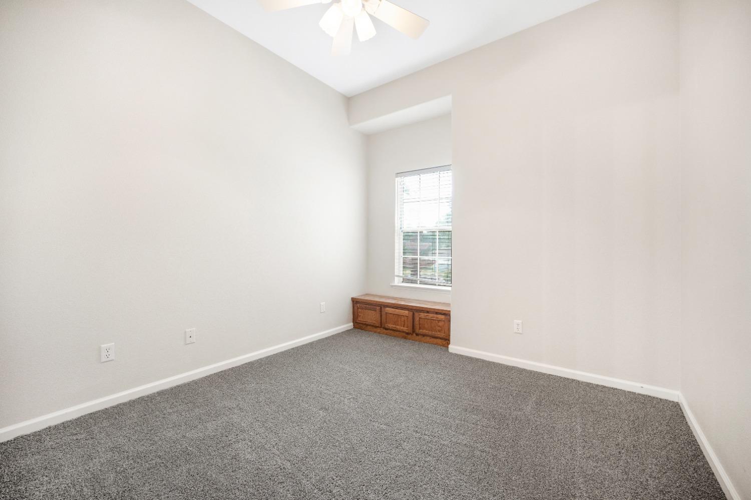 733 Applegate Avenue Clovis, CA 93611 - Photo 13 of 25 an empty room with windows and ceiling fan