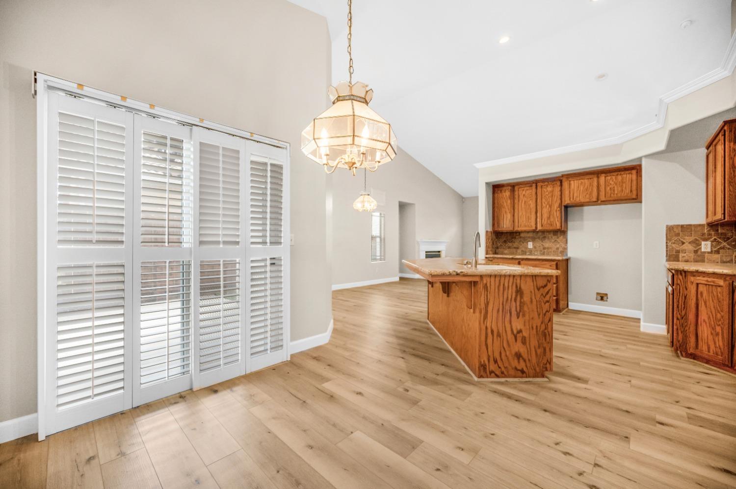733 Applegate Avenue Clovis, CA 93611 - Photo 10 of 25 a view of a kitchen with furniture and wooden floor
