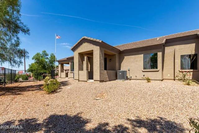 a view of house with swimming pool outdoor seating area