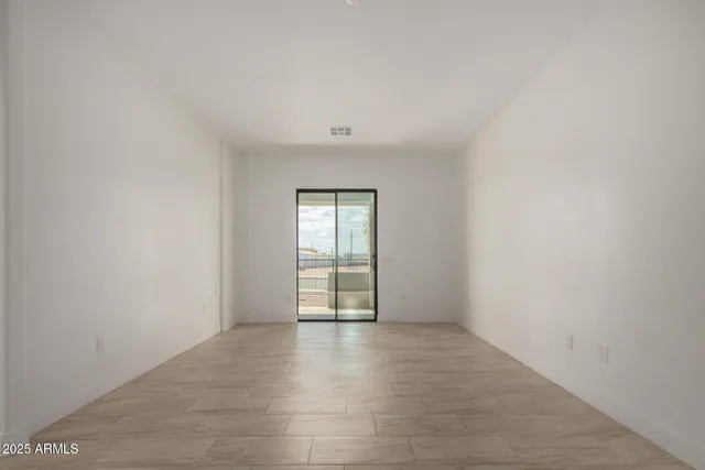 a view of kitchen with kitchen island and stainless steel appliances