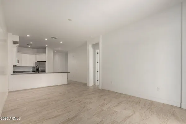 a kitchen with granite countertop white cabinets and stainless steel appliances