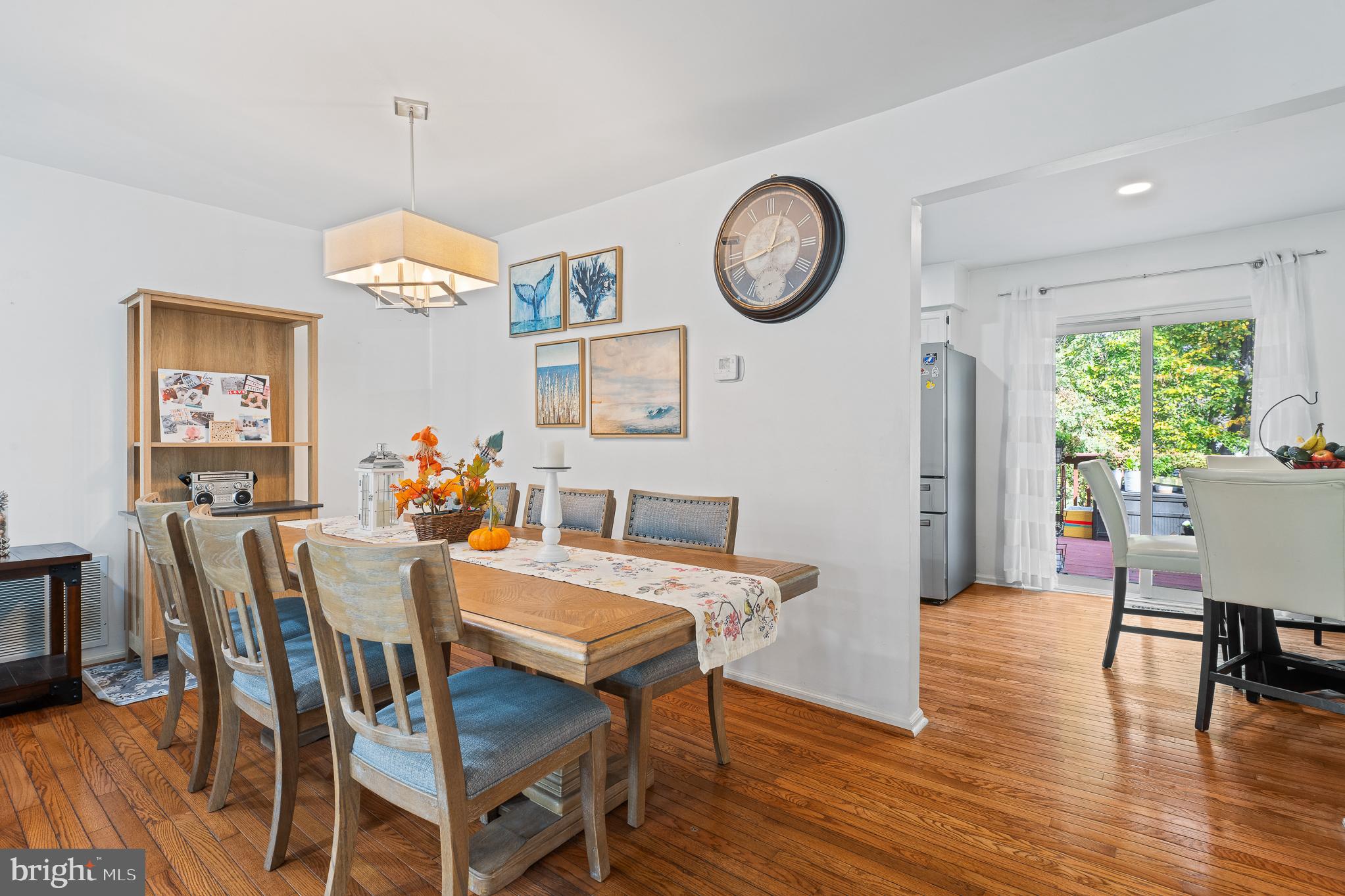 13007 Climbing Ivy Drive Germantown, MD 20874 - Photo 22 of 63 a view of a dining room with furniture a chandelier and wooden floor