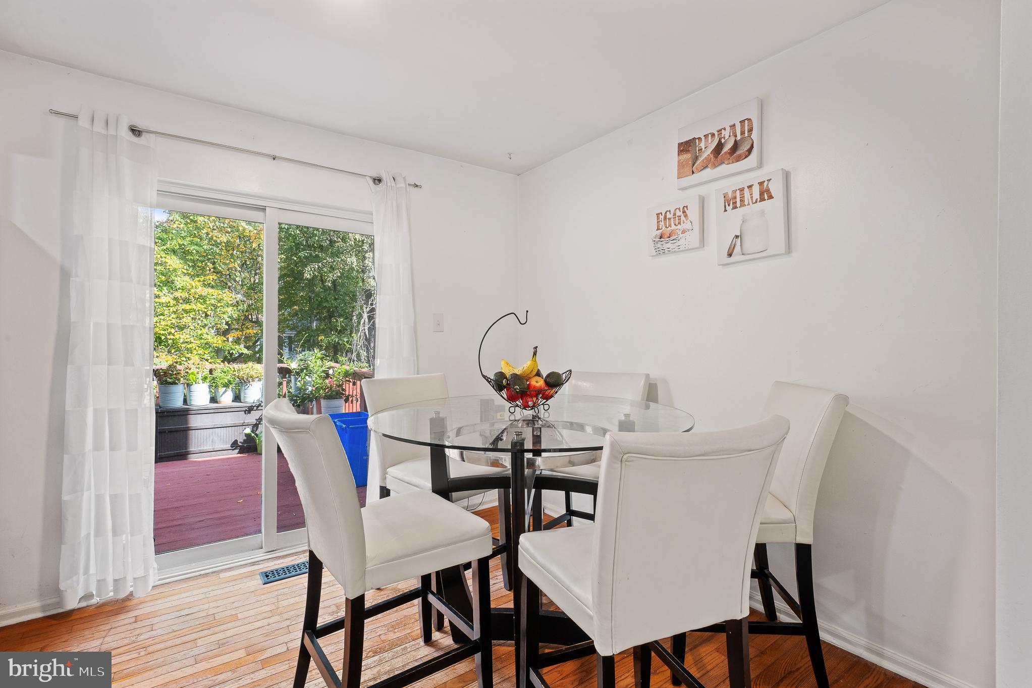 13007 Climbing Ivy Drive Germantown, MD 20874 - Photo 26 of 63 a view of a dining room with furniture window and wooden floor