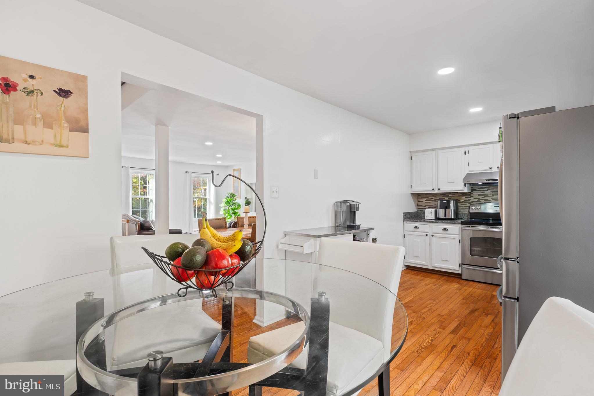 13007 Climbing Ivy Drive Germantown, MD 20874 - Photo 27 of 63 a living room with stainless steel appliances furniture dining table and wooden floor
