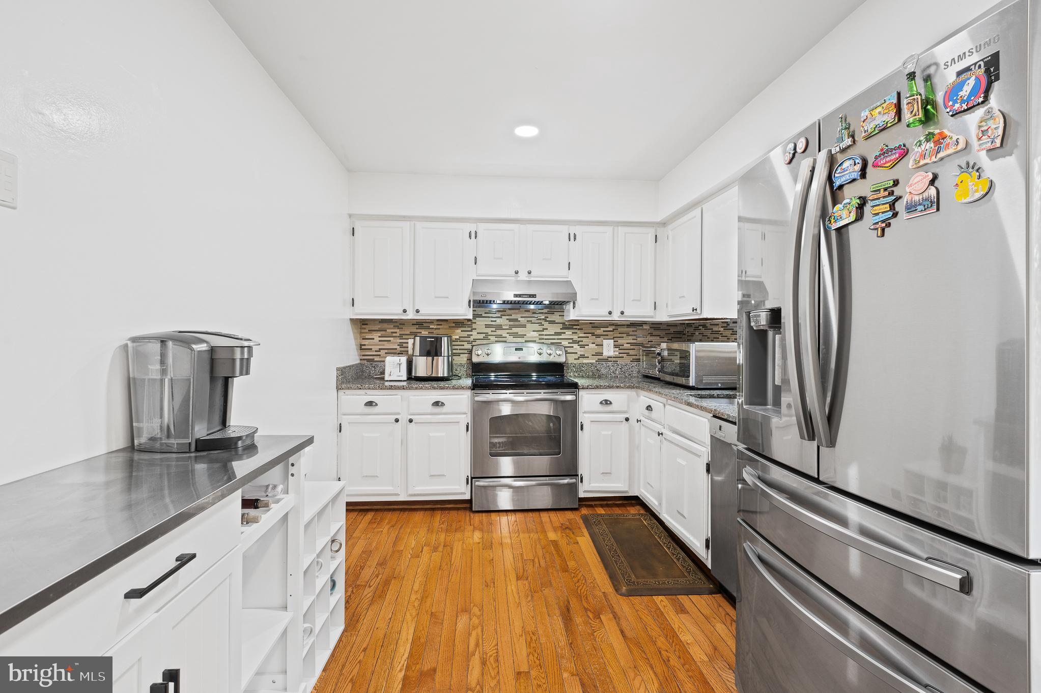 13007 Climbing Ivy Drive Germantown, MD 20874 - Photo 30 of 63 a kitchen with granite countertop stainless steel appliances and refrigerator
