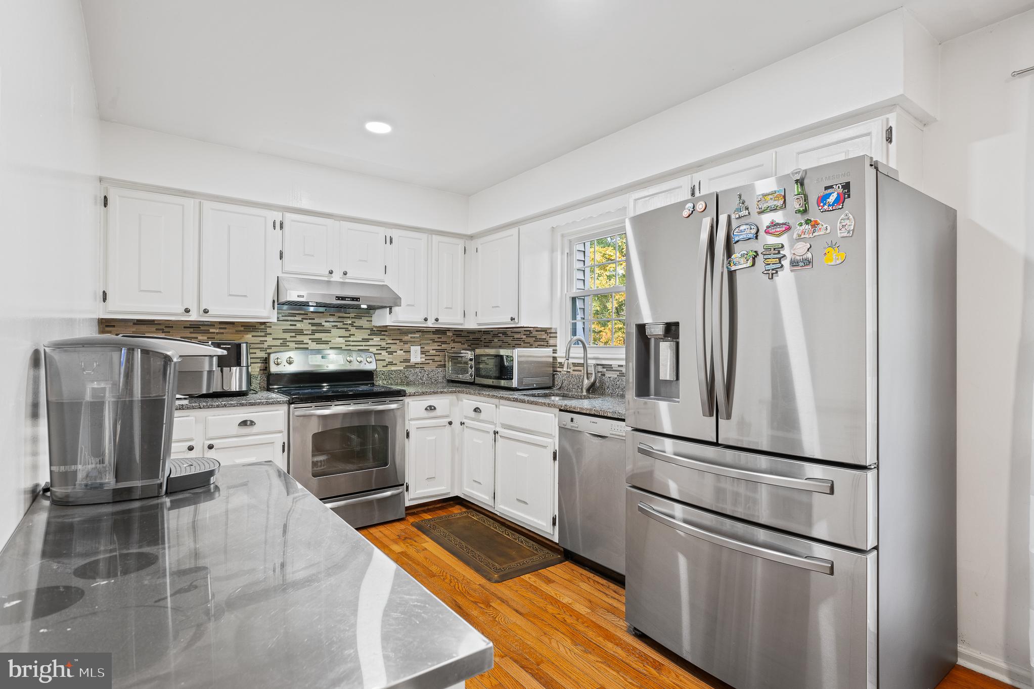 13007 Climbing Ivy Drive Germantown, MD 20874 - Photo 33 of 63 a kitchen with stainless steel appliances a refrigerator sink and microwave