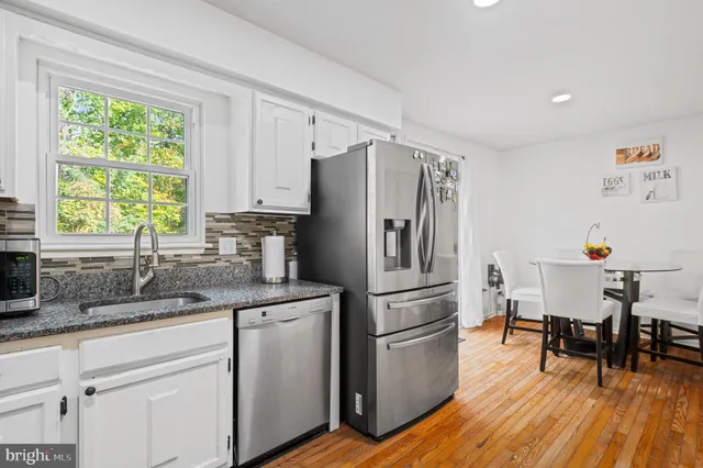 a dining room with furniture and wooden floor