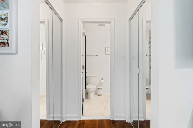 a bed room with a bed and paintings on the wall