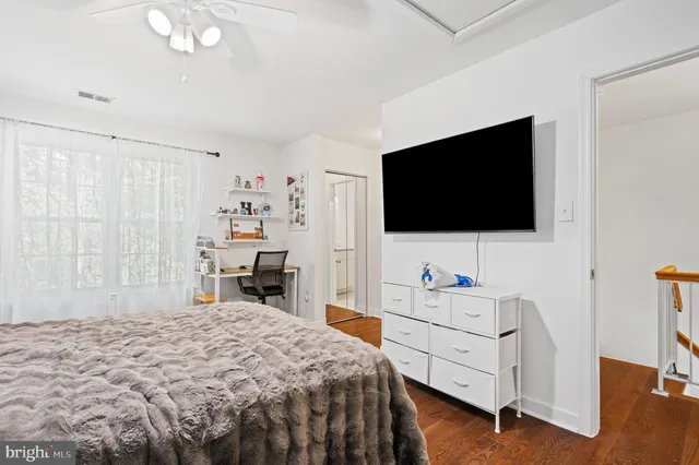 a view of staircase with wooden floor and white walls