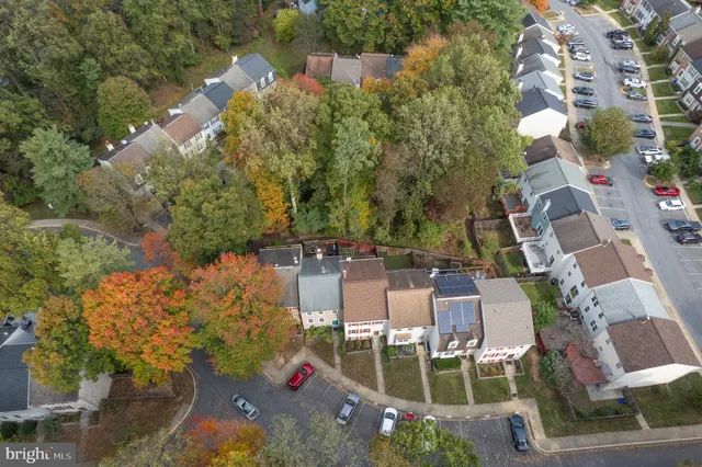 an aerial view of a house with yard and outdoor seating