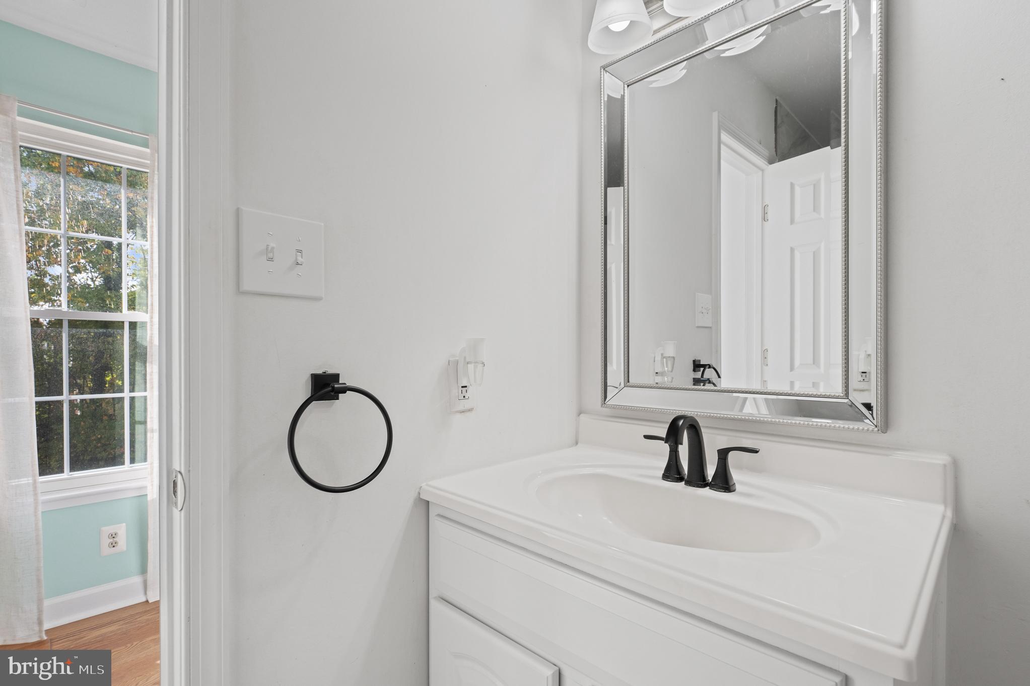 13007 Climbing Ivy Drive Germantown, MD 20874 - Photo 53 of 63 a bathroom with a sink a toilet and a mirror