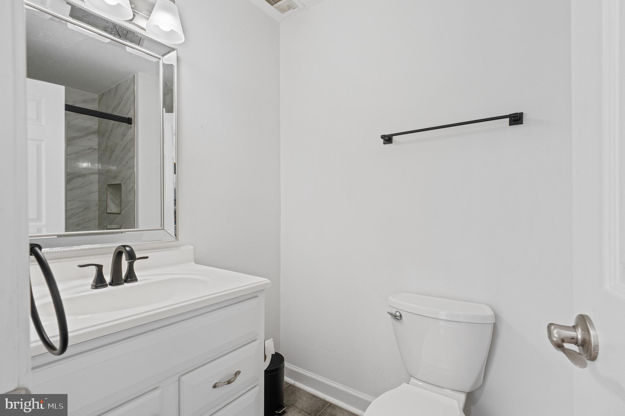 13007 Climbing Ivy Drive Germantown, MD 20874 - Photo 55 of 63 a bathroom with a toilet sink and mirror