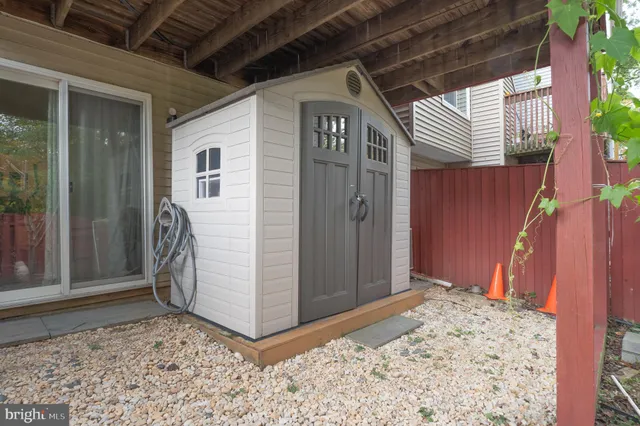 a view of a patio with table and chairs and potted plants